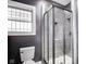 Bathroom featuring glass enclosed shower, modern toilet and window at 3006 W 10Th St, Indianapolis, IN 46222