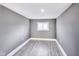 A cozy bedroom featuring light gray walls and light wood-look floors at 3006 W 10Th St, Indianapolis, IN 46222