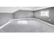 An attic bedroom featuring gray walls, carpet and natural lighting at 3006 W 10Th St, Indianapolis, IN 46222