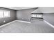 This attic bedroom has a window and angled ceilings with gray walls and carpet at 3006 W 10Th St, Indianapolis, IN 46222