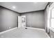 A bedroom with soft carpet, neutral walls, and a view to another room at 3006 W 10Th St, Indianapolis, IN 46222