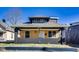 Charming home featuring a welcoming front porch with brick accents and wood siding under a peaked roof at 3006 W 10Th St, Indianapolis, IN 46222