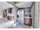 Kitchen area features stainless steel refrigerator, wood flooring, and dark cabinets with light countertop at 3006 W 10Th St, Indianapolis, IN 46222