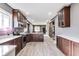Modern kitchen with stainless steel appliances, dark cabinets, light countertops, and wood flooring at 3006 W 10Th St, Indianapolis, IN 46222