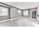 Open living room with wood laminate flooring, neutral paint, and large window at 3006 W 10Th St, Indianapolis, IN 46222