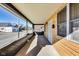 Covered porch with brick accents, wood siding, and a concrete floor at 3006 W 10Th St, Indianapolis, IN 46222