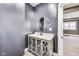 Powder room vanity with soft close cabinet doors, white counter, and round mirror at 3006 W 10Th St, Indianapolis, IN 46222