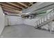 Unfinished basement featuring painted walls and ceiling with open duct work and stairs at 319 Alice St, Shelbyville, IN 46176