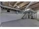 Unfinished basement featuring painted walls and ceiling with open duct work and stairs at 319 Alice St, Shelbyville, IN 46176