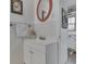 Cozy bathroom featuring a single vanity, tiled walls, a round mirror, and decor; next to the Kitchen at 319 Alice St, Shelbyville, IN 46176