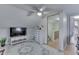 Upstairs bedroom with a ceiling fan, dresser, and television, offering a comfortable and stylish space at 319 Alice St, Shelbyville, IN 46176