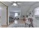 Bright bedroom with a ceiling fan, featuring hardwood floors and a view into another room, exuding comfort at 319 Alice St, Shelbyville, IN 46176