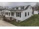 Two-story home with white siding, black shutters, and front porch and side yard at 319 Alice St, Shelbyville, IN 46176