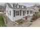 Charming two-story home with white siding, black shutters, and inviting front porch perfect for relaxation at 319 Alice St, Shelbyville, IN 46176