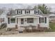 Charming two-story home with white siding, black shutters, and a cozy front porch at 319 Alice St, Shelbyville, IN 46176