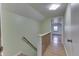Bright hallway featuring stairs, hardwood floors, and neutral-colored walls leading into another room at 319 Alice St, Shelbyville, IN 46176