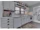 Charming kitchen featuring white cabinets, a window with blinds, and a vintage-inspired decor adding a unique touch at 319 Alice St, Shelbyville, IN 46176