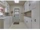 Functional laundry room with ample cabinet storage, laundry machines, and convenient exterior access at 319 Alice St, Shelbyville, IN 46176
