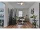 Inviting living room with hardwood floors, complemented by stylish furnishings and plants adding natural elegance at 319 Alice St, Shelbyville, IN 46176
