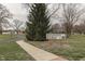 Sign for Kennedy Park with winding sidewalk, mature trees, and playground in distance, perfect for outdoor recreation at 319 Alice St, Shelbyville, IN 46176
