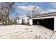 Back yard with patio, spacious driveway, and detached garage at 33 W Mill St, New Palestine, IN 46163