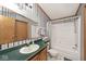 Bathroom featuring green counters, vanity with mirror, toilet, and shower at 33 W Mill St, New Palestine, IN 46163