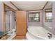 Bathroom featuring tub and shower, toilet, and wood vanity at 33 W Mill St, New Palestine, IN 46163