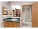 Cozy bathroom featuring vanity with green counters, large mirror, toilet, and shower at 33 W Mill St, New Palestine, IN 46163