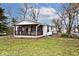 Charming one-story home with a covered porch, burgundy trim, and a well-maintained lawn at 33 W Mill St, New Palestine, IN 46163
