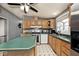 Bright kitchen features wood cabinets, neutral countertops, modern appliances, and ample counter space at 33 W Mill St, New Palestine, IN 46163