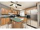 Inviting kitchen features wood cabinets, black appliances, mosaic backsplash, and a center island at 33 W Mill St, New Palestine, IN 46163