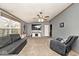 Spacious living room with neutral colored walls, carpet flooring, ceiling fan, and natural lighting at 33 W Mill St, New Palestine, IN 46163