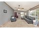 Cozy living room featuring neutral colored walls, carpet flooring, ceiling fan, and natural lighting at 33 W Mill St, New Palestine, IN 46163