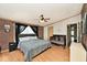 Spacious main bedroom features brick accent wall, wood-look floors, and neutral tones at 33 W Mill St, New Palestine, IN 46163