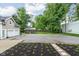 Spacious backyard with a chicken coop, basketball court, and plenty of room to run around at 3447 Washington Blvd, Indianapolis, IN 46205