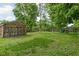 A spacious grassy yard with a chicken coop and a play set for outdoor fun at 3447 Washington Blvd, Indianapolis, IN 46205