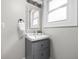 Bathroom vanity with gray drawers, white sink, decorative mirror and lighting at 3447 Washington Blvd, Indianapolis, IN 46205