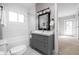 Well-lit bathroom features a vanity with storage and classic white subway tile at 3447 Washington Blvd, Indianapolis, IN 46205