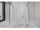 Updated bathroom featuring subway tile surround, modern fixtures, and decorative sliding bard door mirror at 3447 Washington Blvd, Indianapolis, IN 46205