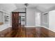 Stylish bedroom featuring hardwood floors, built-in shelving, and a rustic sliding barn door to the closet at 3447 Washington Blvd, Indianapolis, IN 46205