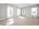 Bright bedroom with neutral carpet, three windows and sheer white curtains at 3447 Washington Blvd, Indianapolis, IN 46205