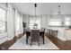 Bright dining room with hardwood floors, natural light, and elegant chandelier, perfect for gatherings at 3447 Washington Blvd, Indianapolis, IN 46205
