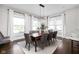 Bright dining room with a wood table, chandelier, large windows and neutral decor at 3447 Washington Blvd, Indianapolis, IN 46205