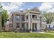 Elegant two-story home featuring grand columns and a manicured lawn, blending classic architecture with modern landscaping at 3447 Washington Blvd, Indianapolis, IN 46205