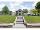 Majestic two-story home with grand columns, sprawling lawn, blending architectural elegance with natural beauty at 3447 Washington Blvd, Indianapolis, IN 46205