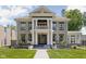 Stately two-story home with elegant columns and landscaped front yard, offering timeless curb appeal and charm at 3447 Washington Blvd, Indianapolis, IN 46205
