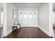 Inviting foyer features a classic door, hardwood floors, and a bench for added convenience at 3447 Washington Blvd, Indianapolis, IN 46205