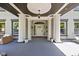 Welcoming front porch showcases columns, elegant lighting, and stylish seating, creating an inviting outdoor living space at 3447 Washington Blvd, Indianapolis, IN 46205