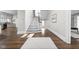 Inviting hallway with hardwood floors, staircase, and natural light, connecting spaces with elegance and charm at 3447 Washington Blvd, Indianapolis, IN 46205