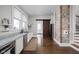 Bright kitchen with granite countertops, white cabinetry, stainless appliances, and exposed brick accent wall at 3447 Washington Blvd, Indianapolis, IN 46205